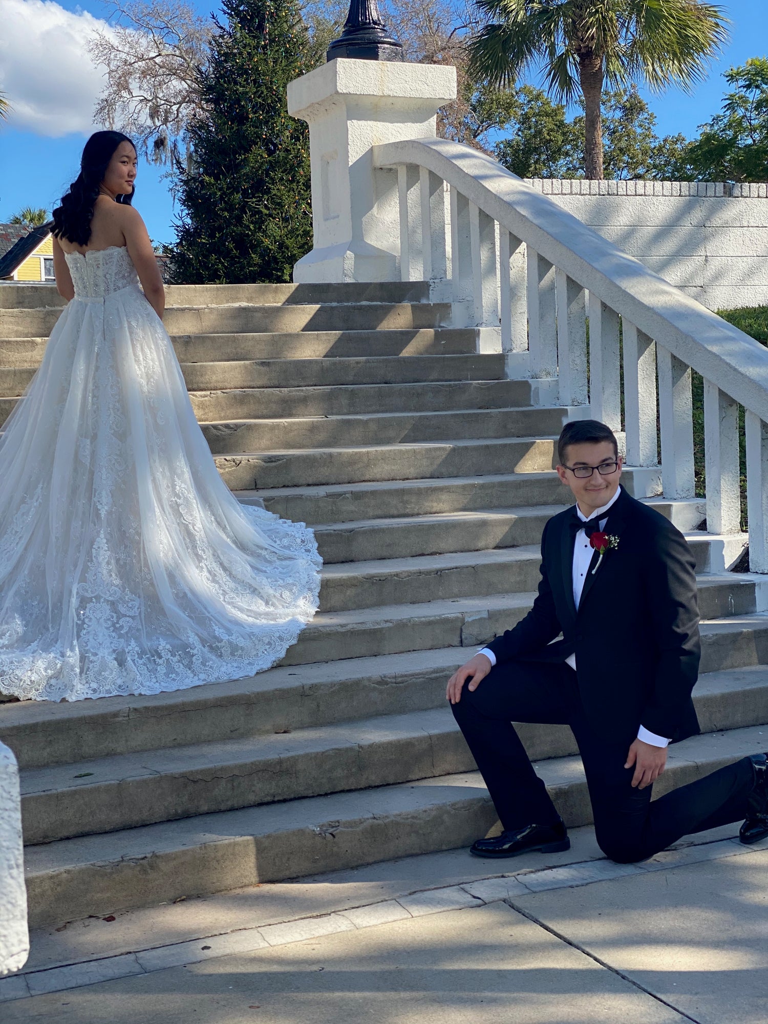 Bride with Long Train on steps with groom